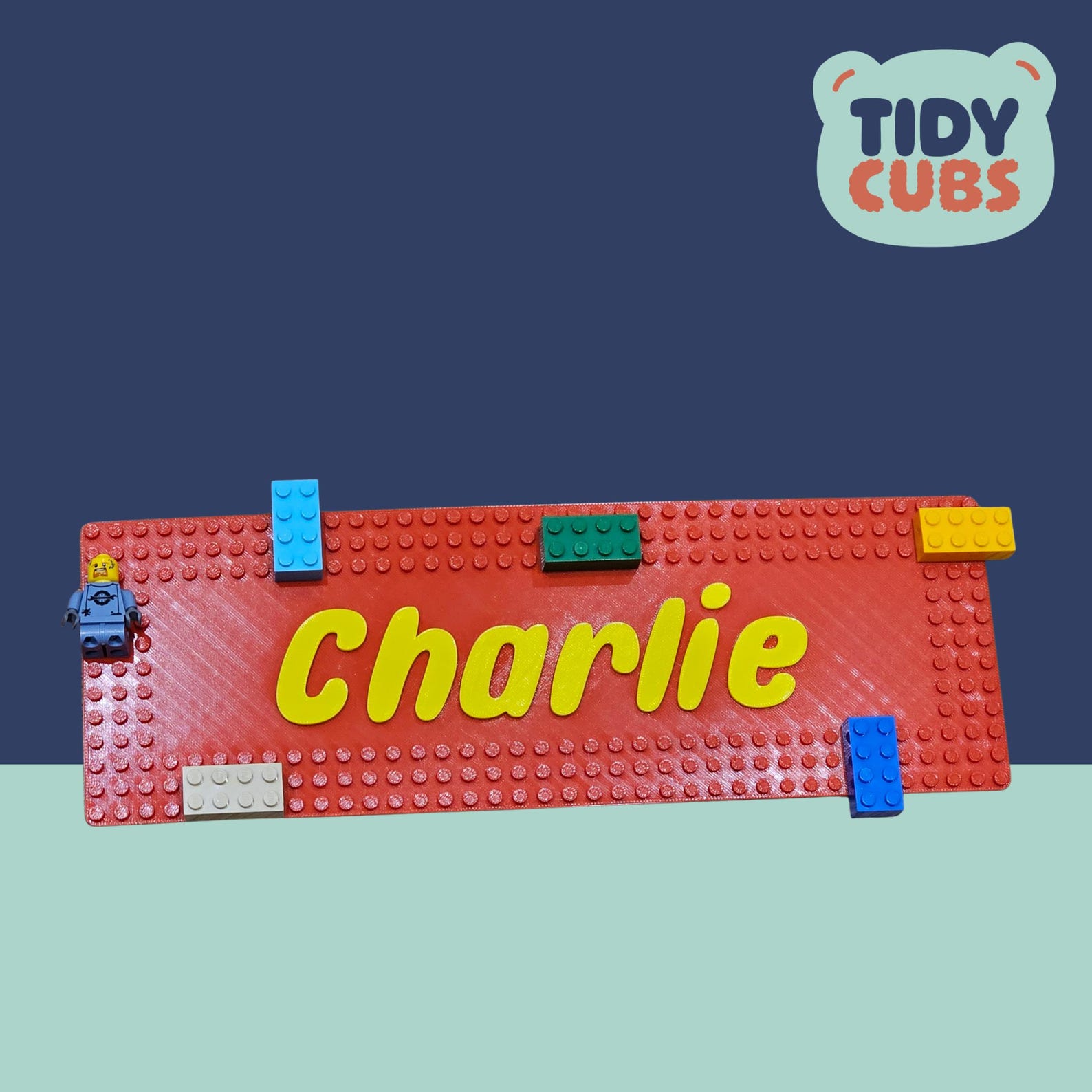 Red brick baseplate door sign with Charlie in yellow raised letters